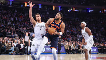 Mar 25, 2025; New York, New York, USA;  New York Knicks center Karl-Anthony Towns (32) drives past Dallas Mavericks center Dwight Powell (7) in the first quarter at Madison Square Garden. Mandatory Credit: Wendell Cruz-Imagn Images