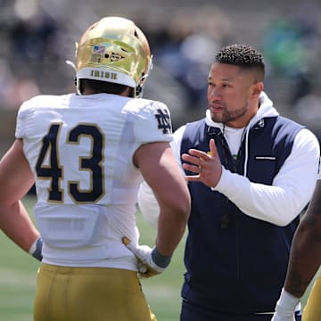 Notre Dame Head Coach Marcus Freeman speaks to Kahanu Kia (43) and Devan Houstan (98) Saturday, April 20, 2024, at the annual Notre Dame Blue-Gold spring football game at Notre Dame Stadium in South Bend.