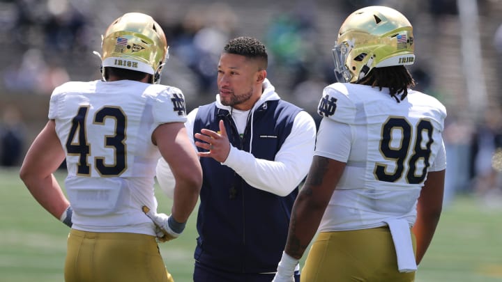 Notre Dame Head Coach Marcus Freeman speaks to Kahanu Kia (43) and Devan Houstan (98) Saturday, April 20, 2024, at the annual Notre Dame Blue-Gold spring football game at Notre Dame Stadium in South Bend.