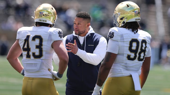 Notre Dame Head Coach Marcus Freeman speaks to Kahanu Kia (43) and Devan Houstan (98) Saturday, April 20, 2024, at the annual Notre Dame Blue-Gold spring football game at Notre Dame Stadium in South Bend.