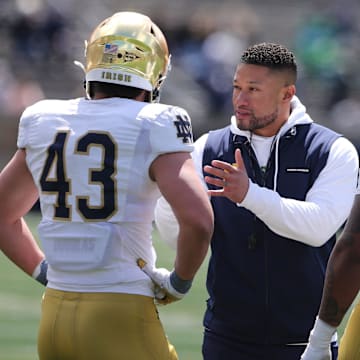 Notre Dame Head Coach Marcus Freeman speaks to Kahanu Kia (43) and Devan Houstan (98) Saturday, April 20, 2024, at the annual Notre Dame Blue-Gold spring football game at Notre Dame Stadium in South Bend.