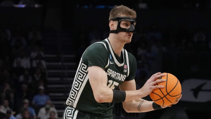 March 23, 2024, Charlotte, NC, USA;  Michigan State Spartans center Carson Cooper (15) controls the ball against the North Carolina Tar Heels in the second round of the 2024 NCAA Tournament at the Spectrum Center. Mandatory Credit: Jim Dedmon-USA TODAY Sports