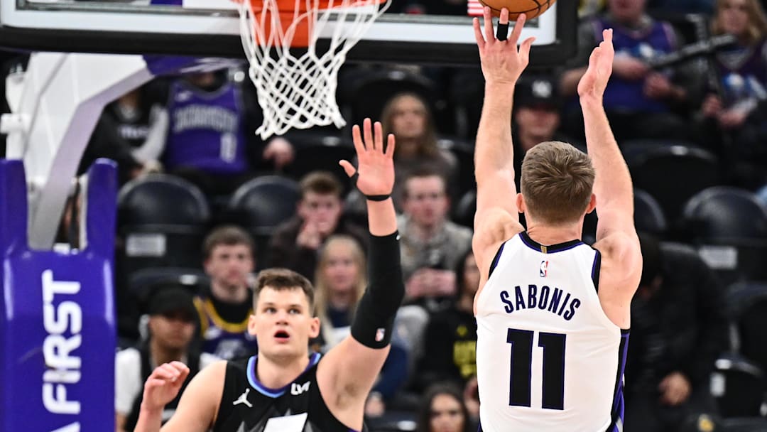 Feb 26, 2025; Salt Lake City, Utah, USA;  Sacramento Kings forward Domantas Sabonis (11) shoots over Utah Jazz center Walker Kessler (24) in the second half at Delta Center. Mandatory Credit: Jamie Sabau-Imagn Images