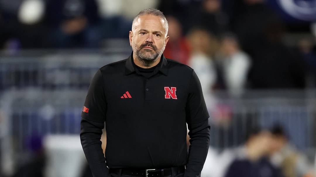 Nov 22, 2025; University Park, Pennsylvania, USA; Nebraska Cornhuskers head coach Matt Rhule stands on the field during a warmup prior to the game against the Penn State Nittany Lions at Beaver Stadium. Mandatory Credit: Matthew O'Haren-Imagn Images