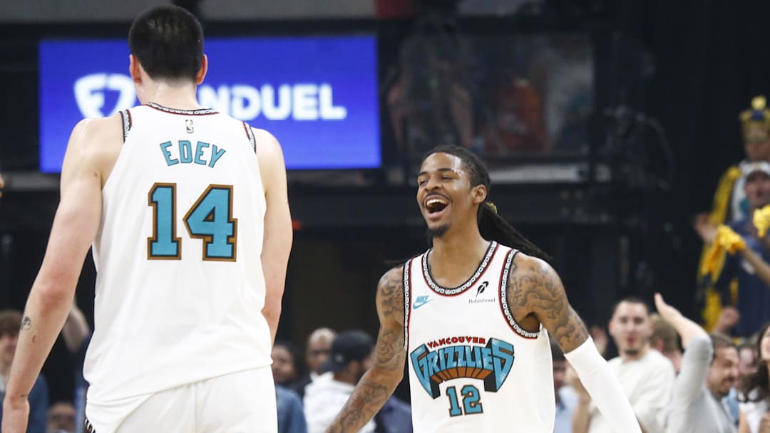 Apr 18, 2025; Memphis, Tennessee, USA; Memphis Grizzlies guard Ja Morant (12) reacts with center Zach Edey (14) during the first quarter against the Dallas Mavericks at FedExForum. Mandatory Credit: Petre Thomas-Imagn Images Apr 18, 2025; Memphis, Tennessee, USA; Memphis Grizzlies guard Ja Morant (12) reacts with center Zach Edey (14) during the first quarter against the Dallas Mavericks at FedExForum. Mandatory Credit: Petre Thomas-Imagn Images