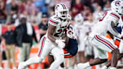Dec 31, 2024; Orlando, FL, USA; South Carolina Gamecocks running back Oscar Adaway III (27) runs the ball against the Illinois Fighting Illini in the. fourth quarter at Camping World Stadium. Mandatory Credit: Jeremy Reper-Imagn Images