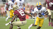 Oct 11, 2025; Tallahassee, Florida, USA; Pittsburgh Panthers running back Desmond Reid (0) runs the ball past Florida State Seminoles defensive back Jerry Wilson (19) during the second half at Doak S. Campbell Stadium. Mandatory Credit: Melina Myers-Imagn Images