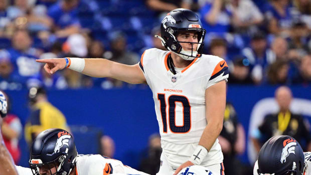 Denver Broncos quarterback Bo Nix (10) points during the second quarter against the Indianapolis Colts at Lucas Oil Stadium. 