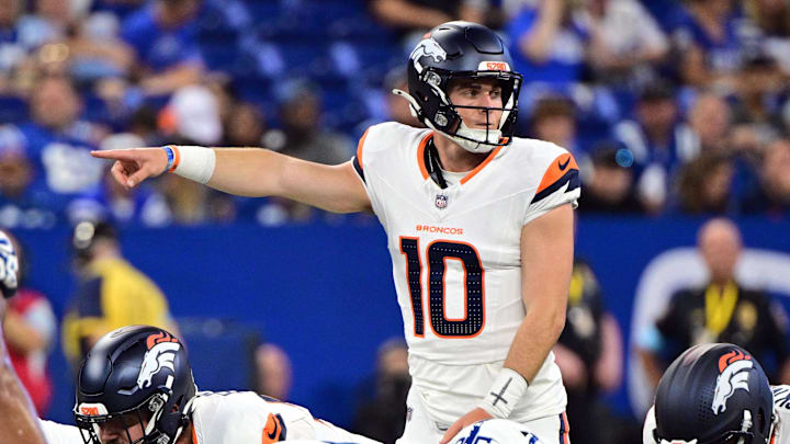 Aug 11, 2024; Indianapolis, Indiana, USA; Denver Broncos quarterback Bo Nix (10) points during the second quarter against the Indianapolis Colts at Lucas Oil Stadium. Mandatory Credit: Marc Lebryk-Imagn Images