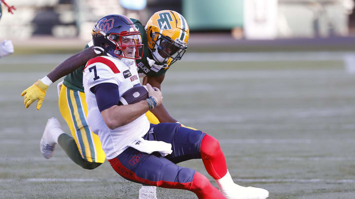 Jun 14, 2024; Edmonton, Alberta, CAN; Edmonton Elks defensive back Kordell Jackson (15) tackles Montreal Alouettes quarterback Cody Fajardo (7) during the first half at Commonwealth Stadium. Mandatory Credit: Perry Nelson-USA TODAY Sports