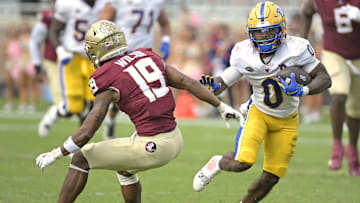 Oct 11, 2025; Tallahassee, Florida, USA; Pittsburgh Panthers running back Desmond Reid (0) runs the ball past Florida State Seminoles defensive back Jerry Wilson (19) during the second half at Doak S. Campbell Stadium. Mandatory Credit: Melina Myers-Imagn Images