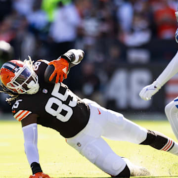 Sep 8, 2024; Cleveland, Ohio, USA; Cleveland Browns tight end David Njoku (85) falls while running the ball under coverage by Dallas Cowboys cornerback Trevon Diggs (7) during the first quarter at Huntington Bank Field. Mandatory Credit: Scott Galvin-Imagn Images