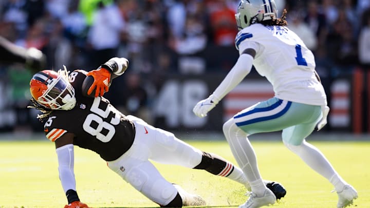 Sep 8, 2024; Cleveland, Ohio, USA; Cleveland Browns tight end David Njoku (85) falls while running the ball under coverage by Dallas Cowboys cornerback Trevon Diggs (7) during the first quarter at Huntington Bank Field. Mandatory Credit: Scott Galvin-Imagn Images