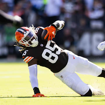 Sep 8, 2024; Cleveland, Ohio, USA; Cleveland Browns tight end David Njoku (85) falls while running the ball under coverage by Dallas Cowboys cornerback Trevon Diggs (7) during the first quarter at Huntington Bank Field. Mandatory Credit: Scott Galvin-Imagn Images