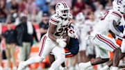 Dec 31, 2024; Orlando, FL, USA; South Carolina Gamecocks running back Oscar Adaway III (27) runs the ball against the Illinois Fighting Illini in the. fourth quarter at Camping World Stadium. Mandatory Credit: Jeremy Reper-Imagn Images