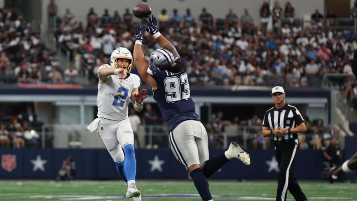 Aug 24, 2024; Arlington, Texas, USA; Los Angeles Chargers quarterback Easton Stick (2) throws a pass against Dallas Cowboys defensive lineman Viliami Fehoko (93) in the second quarter at AT&T Stadium. Mandatory Credit: Tim Heitman-USA TODAY Sports