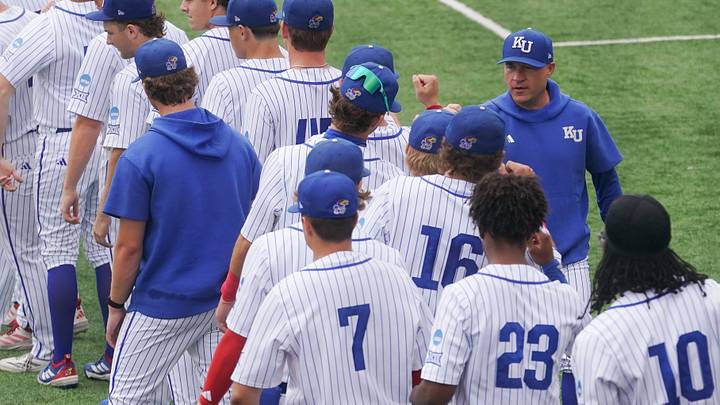 Kansas coach Dan Fitzgerald fist bumps players before taking on Northeastern during the NCAA First Round of the Lawrence Regional at Hoglund Ballpark on May 29, 2026.