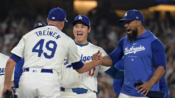Oct 11, 2024; Los Angeles, California, USA; Los Angeles Dodgers outfielder Teoscar Hernandez (37) and designated hitter Shohei Ohtani (17) and pitcher Blake Treinen (49) celebrate after defeating the San Diego Padres in game five of the NLDS for the 2024 MLB Playoffs at Dodger Stadium. Mandatory Credit: Jayne Kamin-Oncea-Imagn Images