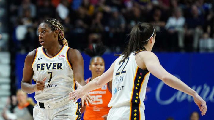 Jun 10, 2024; Uncasville, Connecticut, USA; Indiana Fever forward Aliyah Boston (7) and guard Caitlin Clark (22) react after a basket against the Connecticut Sun in the first quarter at Mohegan Sun Arena. Mandatory Credit: David Butler II-USA TODAY Sports