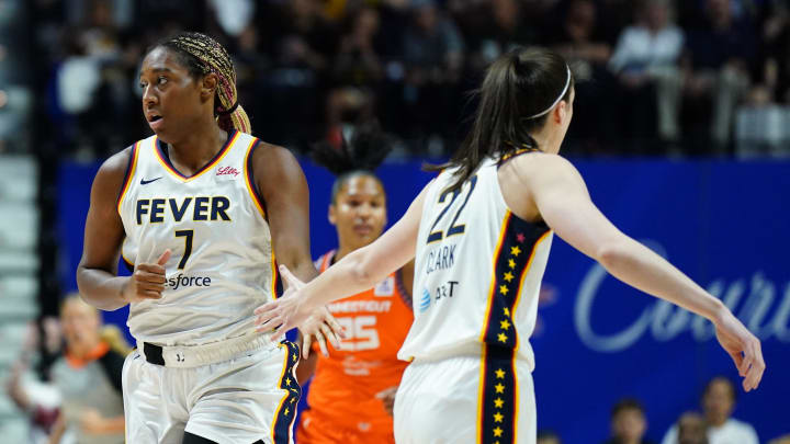 Indiana Fever forward Aliyah Boston and guard Caitlin Clark react after a basket against the Connecticut Sun in the first quarter at Mohegan Sun Arena.