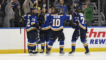 Apr 15, 2025; St. Louis, Missouri, USA; St. Louis Blues right wing Jordan Kyrou (25) is congratulated by teammates after scoring a goal against the Utah Hockey Club during the third period at Enterprise Center. Mandatory Credit: Jeff Le-Imagn Images