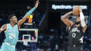 Mar 31, 2024; Charlotte, North Carolina, USA; LA Clippers forward Paul George (13) shoots a three-point shot against Charlotte Hornets forward Brandon Miller (24) during the second half at Spectrum Center. Mandatory Credit: Jim Dedmon-USA TODAY Sports