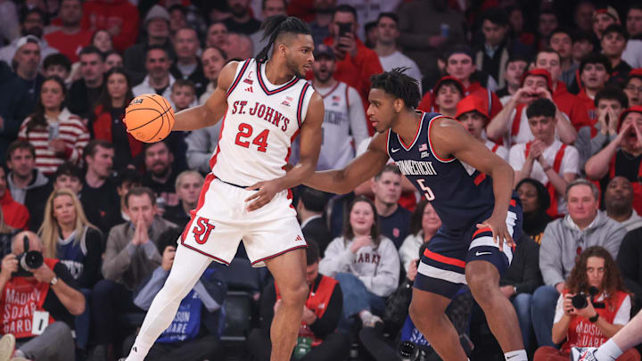 Feb 6, 2026; New York, New York, USA;  St. John's basketball forward Zuby Ejiofor (24) looks to drive past UConn Huskies forward Tarris Reed Jr. (5) in the first half at Madison Square Garden.