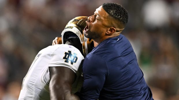 Marcus Freeman hugs a Notre Dame player during the win over Texas A&M