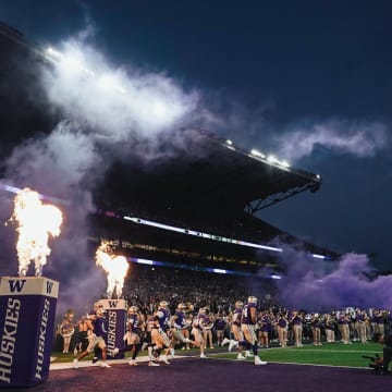 The Huskies emerge from the tunnel to a flaming field entry.