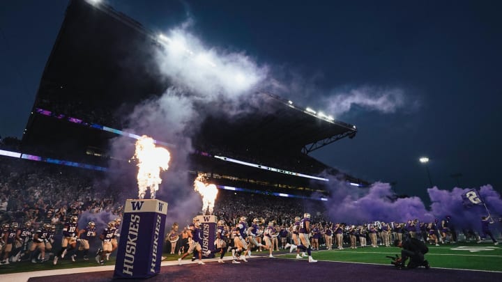 The Huskies emerge from the tunnel to a flaming field entry.