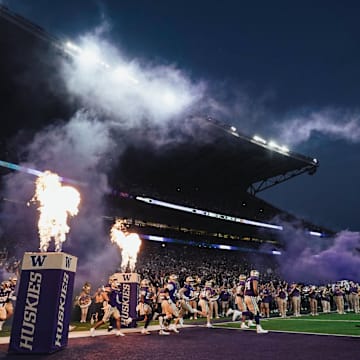 The Huskies run out of the tunnel for a night game in 2024. 