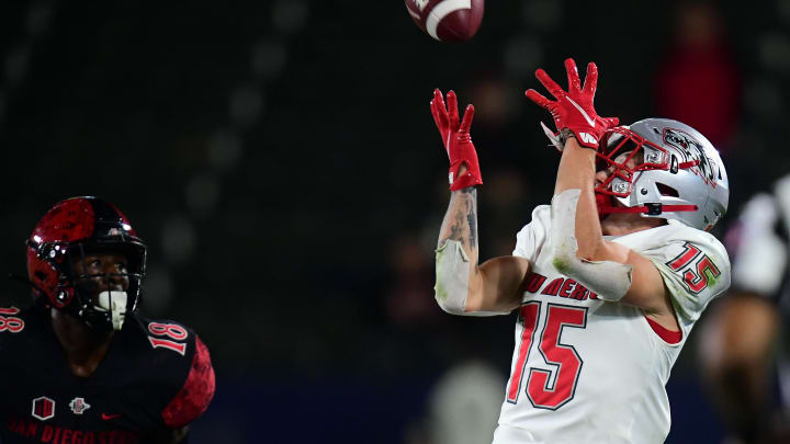 Oct 9, 2021; Carson, California, USA; New Mexico Lobos wide receiver Luke Wysong (15) catches a pass against the defense of San Diego State Aztecs safety Trenton Thompson (18) during the second half at Dignity Health Sports Park. Mandatory Credit: Gary A. Vasquez-USA TODAY Sports