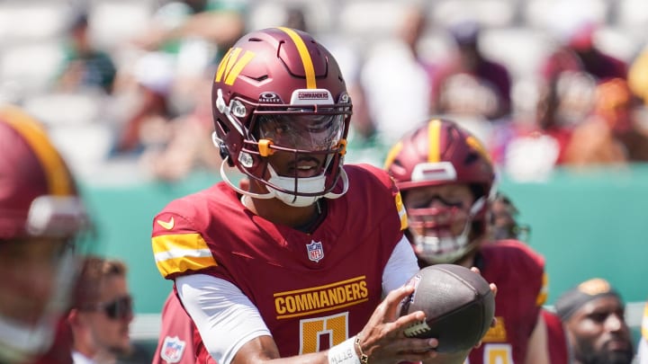 Aug 10, 2024; East Rutherford, New Jersey, USA; Washington Commanders quarterback Jayden Daniels (5) warms up before the game against the New York Jets at MetLife Stadium. Mandatory Credit: Lucas Boland-USA TODAY Sports