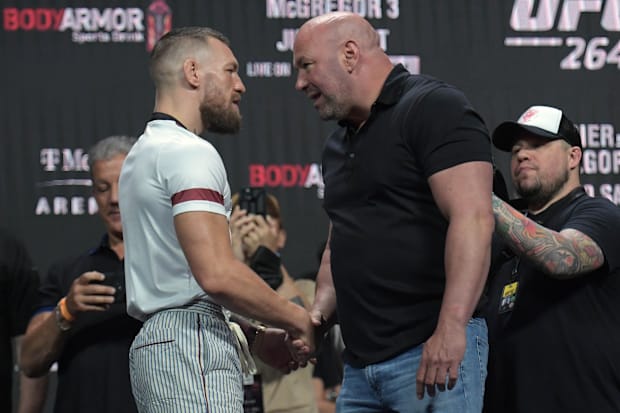 Conor McGregor is greeted by UFC CEO Dana White during weigh-ins for UFC 264 at T-Mobile Arena. 