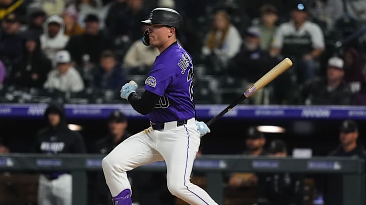 Apr 6, 2026; Denver, Colorado, USA; Colorado Rockies right fielder Troy Johnston (20) RBI doubles in the fifth inning against the Houston Astros at Coors Field. Mandatory Credit: Ron Chenoy-Imagn Images
