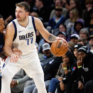 Dallas Mavericks guard Luka Doncic (77) dribbles as Memphis Grizzlies guard Derrick Rose (23) during the second half at FedExForum. 