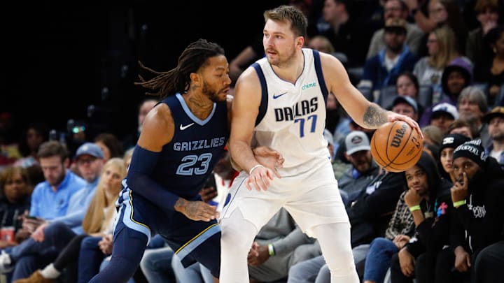 Dallas Mavericks guard Luka Doncic (77) dribbles as Memphis Grizzlies guard Derrick Rose (23) during the second half at FedExForum. 