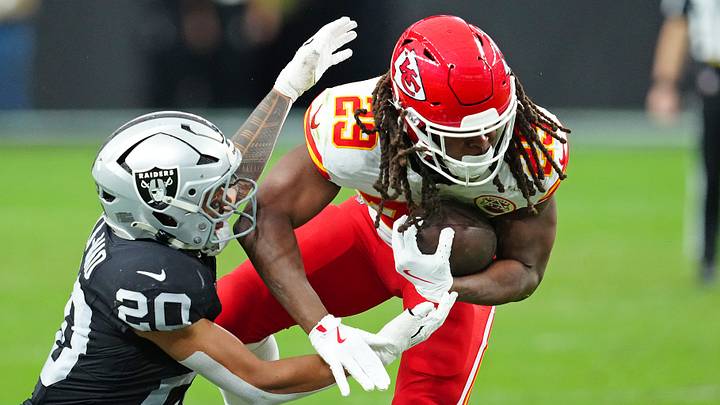 Jan 4, 2026; Paradise, Nevada, USA; Las Vegas Raiders safety Isaiah Pola-Mao (20) looks to tackle Kansas City Chiefs running back Kareem Hunt (29) during the second quarter at Allegiant Stadium. Mandatory Credit: Stephen R. Sylvanie-Imagn Images