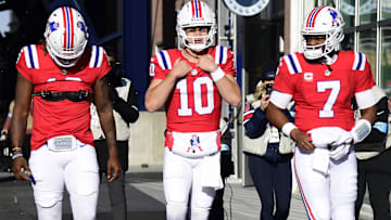 Quarterbacks Joe Milton III (19), Drake Maye (10), and Jacoby Brissett (7) take the field for warmups prior to a game against the Indianapolis Colts at Gillette Stadium.