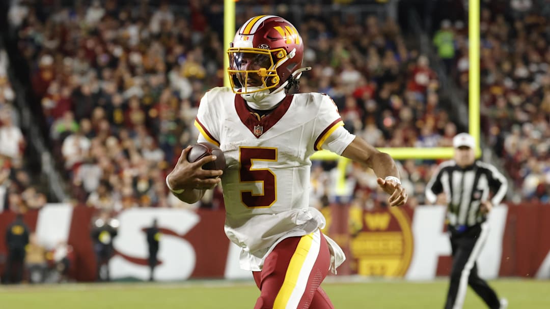 Washington Commanders quarterback Jayden Daniels (5) runs the ball against the Seattle Seahawks during the first half at Northwest Stadium. Mandatory Credit: Amber Searls-Imagn Images