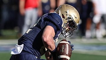 Oct 26, 2024; East Rutherford, New Jersey, USA; Navy Midshipmen running back Eli Heidenreich (22) can not secure a punt during the second half against the Notre Dame Fighting Irish at MetLife Stadium. Mandatory Credit: Vincent Carchietta-Imagn Images
