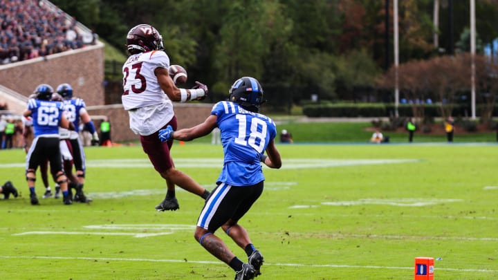 Nov 12, 2022; Durham, North Carolina, USA; Virginia Tech Hokies defensive back Mansoor Delane (23) intercepts the ball from Duke Blue Devils wide receiver Malik Bowen-Sims (18) during the first half against Virginia Tech at Wallace Wade Stadium. Mandatory Credit: Jaylynn Nash-USA TODAY Sports