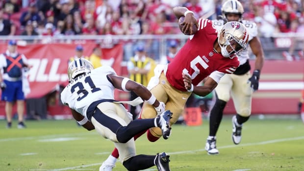 San Francisco 49ers quarterback Joshua Dobbs (5) runs past New Orleans Saints safety Jordan Howden (31) for a score 