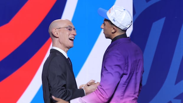 Jun 25, 2025; Brooklyn, NY, USA;  Nique Clifford greets NBA commissioner Adam Silver after being selected as the 24th pick by