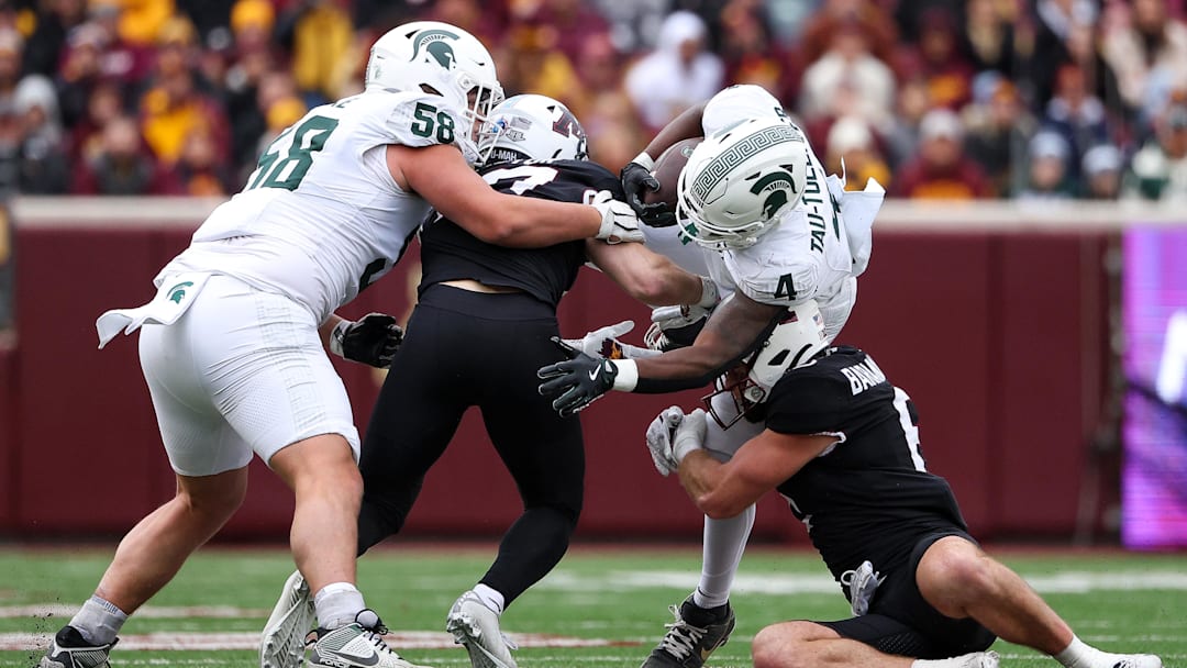 Nov 1, 2025; Minneapolis, Minnesota, USA; Michigan State Spartans running back Elijah Tau-Tolliver (4) runs the ball against the Minnesota Golden Gophers during the first half at Huntington Bank Stadium. Mandatory Credit: Matt Krohn-Imagn Images
