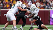 Nov 1, 2025; Minneapolis, Minnesota, USA; Michigan State Spartans running back Elijah Tau-Tolliver (4) runs the ball against the Minnesota Golden Gophers during the first half at Huntington Bank Stadium. Mandatory Credit: Matt Krohn-Imagn Images