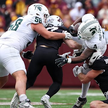 Nov 1, 2025; Minneapolis, Minnesota, USA; Michigan State Spartans running back Elijah Tau-Tolliver (4) runs the ball against the Minnesota Golden Gophers during the first half at Huntington Bank Stadium. Mandatory Credit: Matt Krohn-Imagn Images