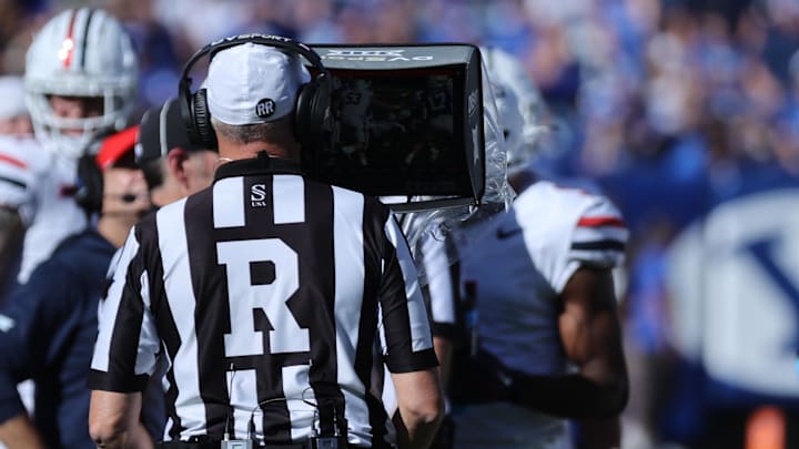 Oct 12, 2024; Provo, Utah, USA; Big 12 Referee Mike McCabe reviews a call during the second quarter of a game between the Brigham Young Cougars and the Arizona Wildcats at LaVell Edwards Stadium. Mandatory Credit: Rob Gray-Imagn Images