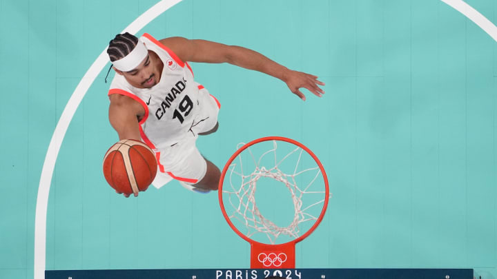 Aug 2, 2024; Villeneuve-d'Ascq, France; Canada point guard Andrew Nembhard (19) shoots against Spain in the first half in a men’s group A basketball game during the Paris 2024 Olympic Summer Games at Stade Pierre-Mauroy. Mandatory Credit: John David Mercer-USA TODAY Sports