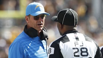Sep 22, 2024; Pittsburgh, Pennsylvania, USA;  Los Angeles Chargers head coach Jim Harbaugh (left) talks with field judge Sean Petty (28) against the Pittsburgh Steelers during the fourth quarter at Acrisure Stadium. Pittsburgh won 20-10. Mandatory Credit: Charles LeClaire-Imagn Images